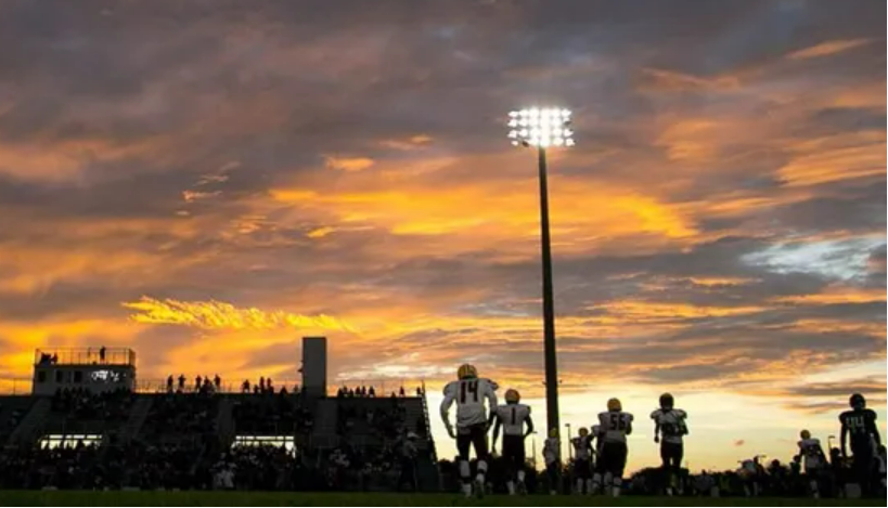 A Friday night football game hosted by the Lions of Olympic Heights High School. Homes will soon be built adjacent to the football stadium as part of a high-end development to be built by GL homes. The homebuilder recently received permission to build a wide buffer and high walls to mitigate noise impacts.