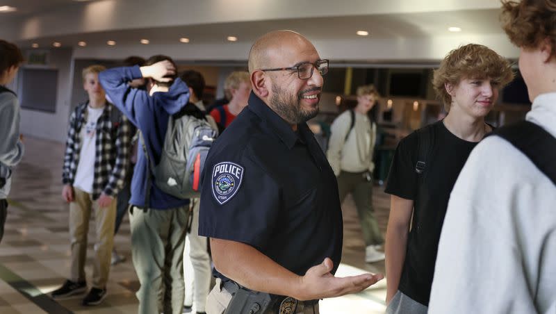 Unified Police SRO Detective Jaime Cardenas speaks with students at Olympus High School in Holladay on Thursday, Feb. 2, 2023. Cardenas has been an SRO, a sworn law enforcement officer responsible for safety and crime prevention in schools, at Olympus High for four years.