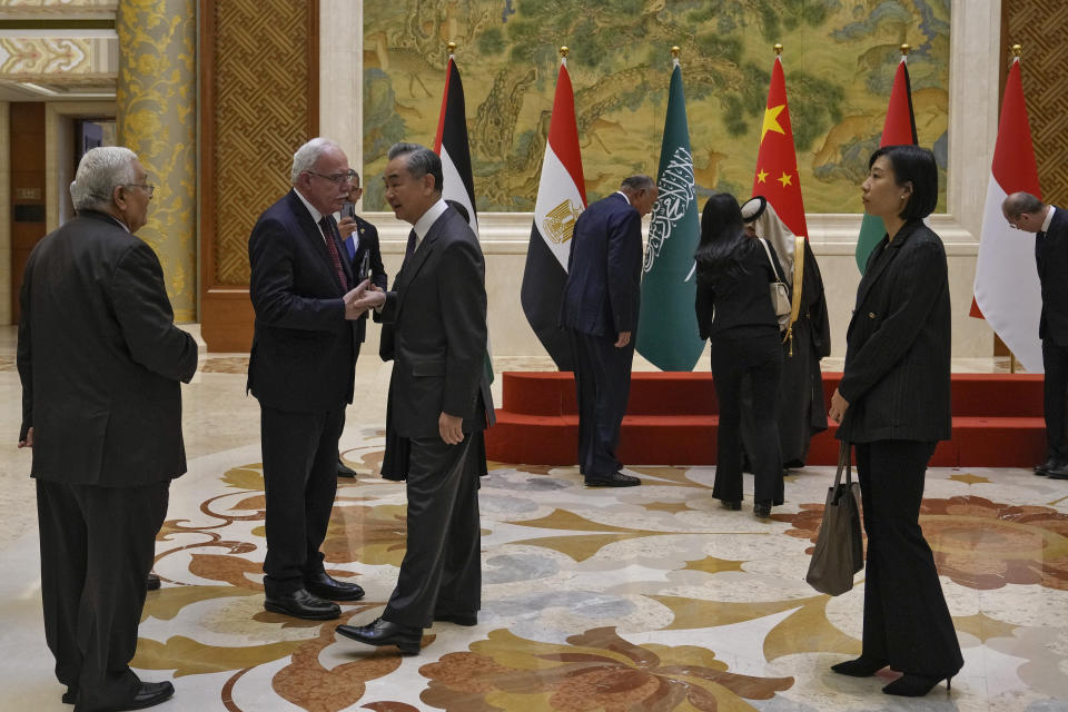 Chinese Foreign Minister Wang Yi, third from left, shakes hands with Palestine Foreign Minister Riyad al-Maliki as he meets with his five Arab and Islamic counterparts at the Diaoyutai state guesthouse in Beijing, Monday, Nov. 20, 2023. China's foreign minister welcomed five Arab and Islamic counterparts to Beijing on Monday, saying his country would work with "our brothers and sisters" in the Arab and Islamic world to try to end the fighting in Gaza as soon as possible. (AP Photo/Andy Wong)