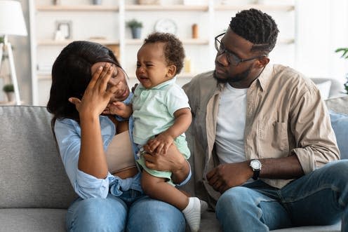 <span class="caption">Postnatal depression can affect both mothers and fathers.</span> <span class="attribution"><a class="link " href="https://www.shutterstock.com/image-photo/portrait-tired-black-mum-sitting-her-2034494657" rel="nofollow noopener" target="_blank" data-ylk="slk:Prostock-studio/ Shutterstock;elm:context_link;itc:0;sec:content-canvas">Prostock-studio/ Shutterstock</a></span>