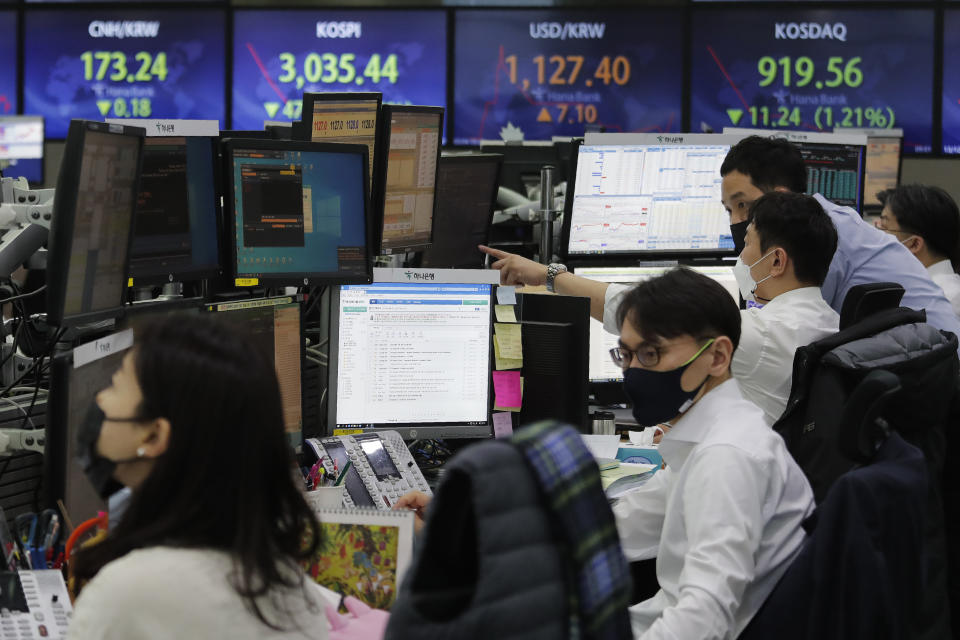 Currency traders watch monitors at the foreign exchange dealing room of the KEB Hana Bank headquarters in Seoul, South Korea, Thursday, March 4, 2021. Asian shares fell Thursday, tracking a decline on Wall Street as another rise in bond yields rattled investors who worry that higher inflation may prompt central banks to raise ultra-low interest rates. (AP Photo/Ahn Young-joon)