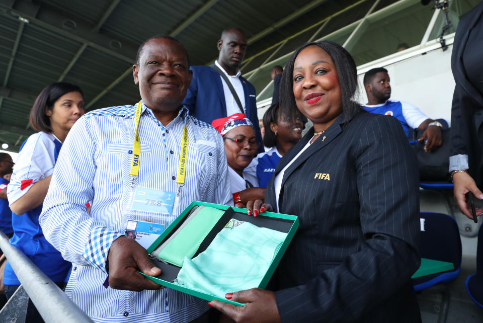 SAINT-MALO, FRANCE - AUGUST 06: FIFA Secretary General Fatma Samoura presents a gift to Yves Jean-Bart president of the Haiti Football Association during the FIFA U-20 Women's  World Cup France 2018 group D match between Haiti and China PR at  on August 6, 2018 in Saint-Malo, France. (Photo by Catherine Ivill - FIFA/FIFA via Getty Images) 