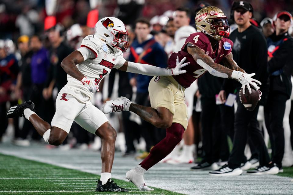 Louisville defensive back Quincy Riley, left, defends on an incomplete pass to Florida State wide receiver Keon Coleman during the first half of the Atlantic Coast Conference championship NCAA college football game Saturday, Dec. 2, 2023, in Charlotte, N.C.