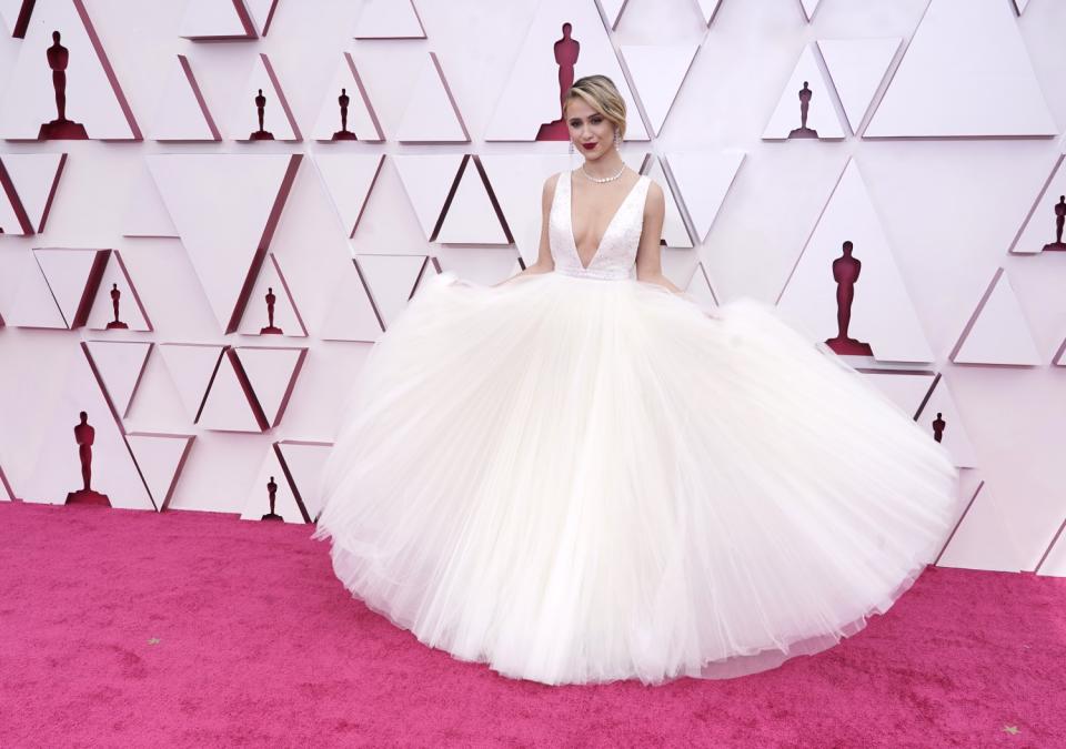 Maria Bakalova in a white dress with a voluminous tulle skirt and a plunging neckline.