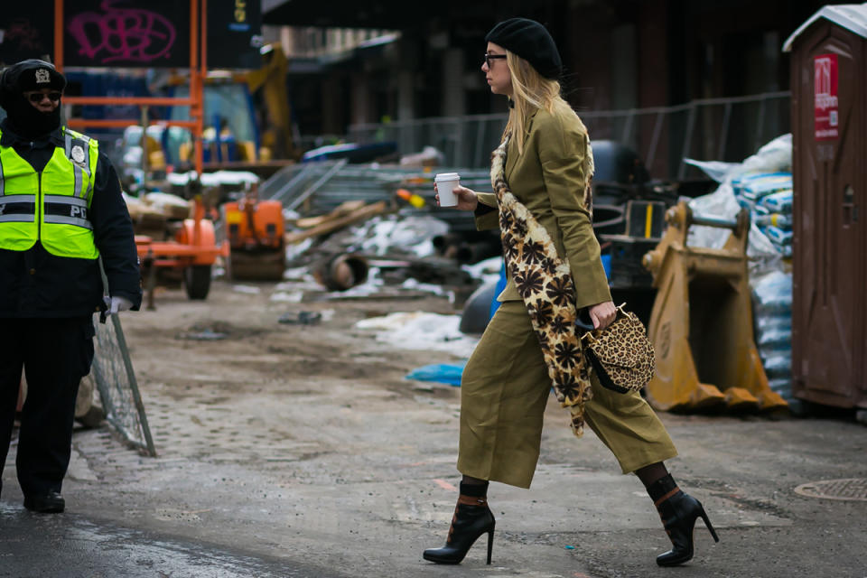 A show-goer heads to Tory Burch at New York Fashion Week.