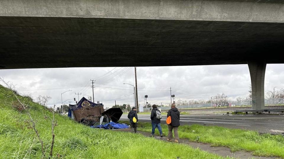 From left, Outreach workers Greg Stupplebeen, John Harding and Afton Francik, who work for the nonprofit homeless services organization Hope Cooperative, comb the streets of Sacramento searching for homeless people who need housing and services.