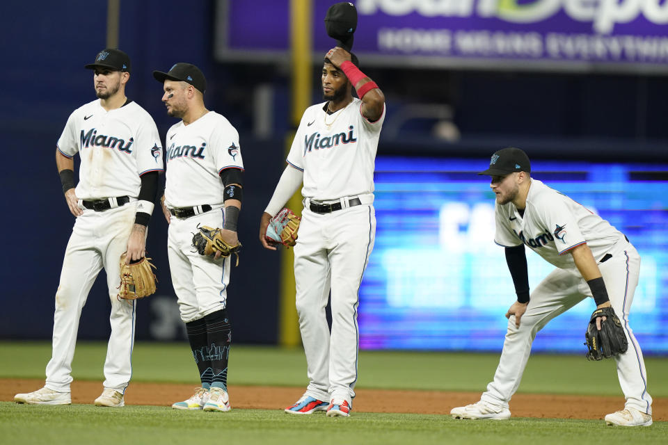 Miami Marlins third baseman Jordan Groshans, shortstop Miguel Rojas, first baseman Lewin Diaz and second baseman Charles Leblanc, from left, stand on the field during a pitching change in the eighth inning of the team's baseball game against the Chicago Cubs, Wednesday, Sept. 21, 2022, in Miami. The Cubs won 4-3. (AP Photo/Lynne Sladky)