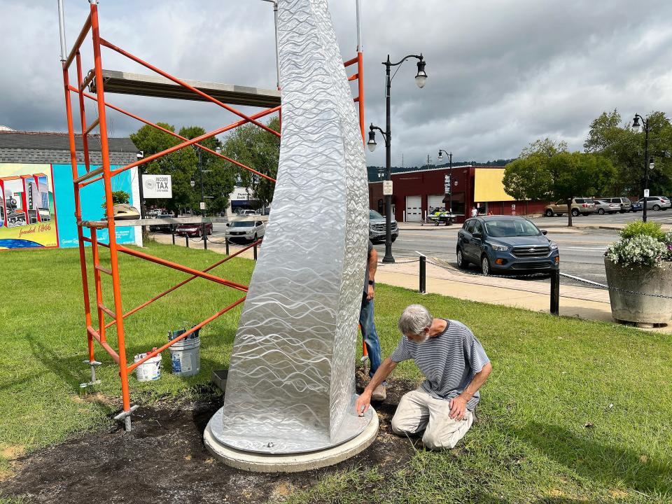 Artist Harry McDaniel installs the base of "River Whiskers," his kinetic statue commissioned by the Gadsden Public Arts Project, on Aug. 15, 2023, in a lot at the corner of Broad and First streets in downtown Gadsden.