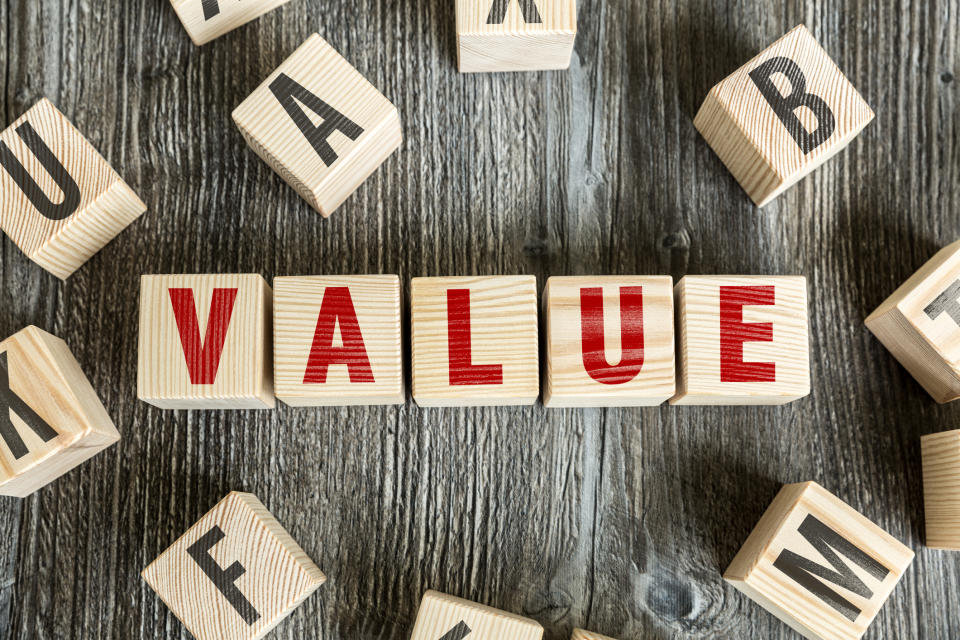 The word value spelled out with red letters on wooden blocks.