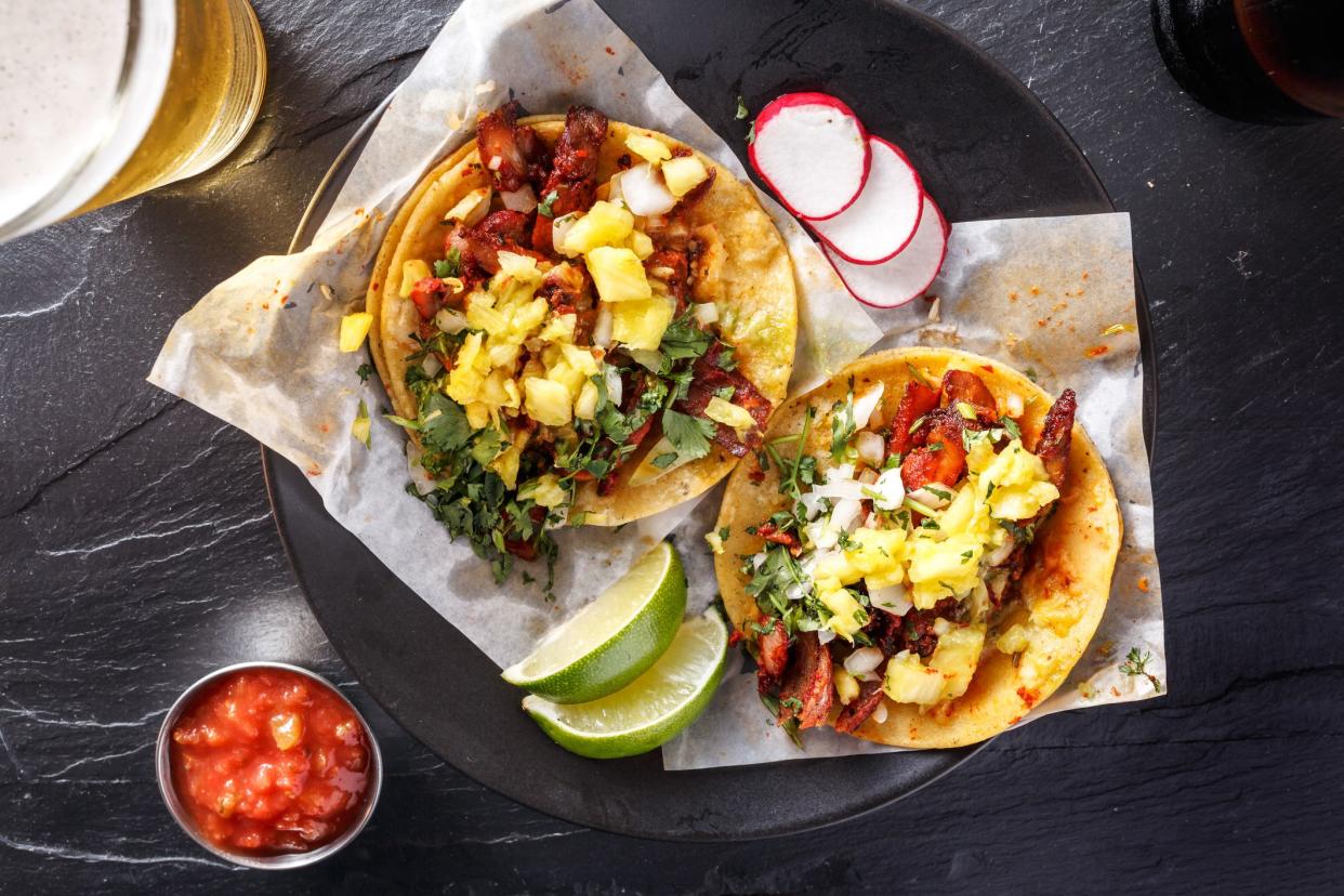 mexican street tacos with beer shot top down on slate surface