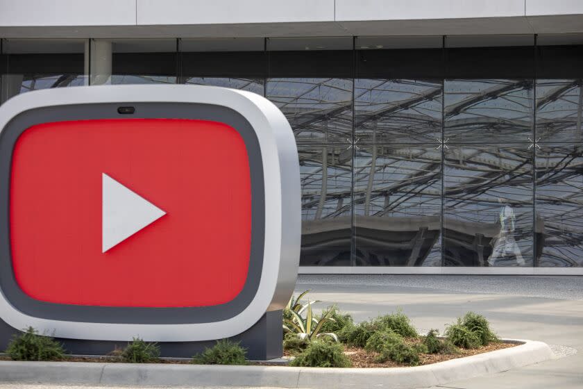 Inglewood, CA - July 23- SoFi Stadium is reflected in the glass exterior of the new YouTube Theater, a 6,000 seat performance venue that is part of a larger complex called Hollywood Park on Friday, July 23, 2021 in Inglewood, CA. (Brian van der Brug / Los Angeles Times)