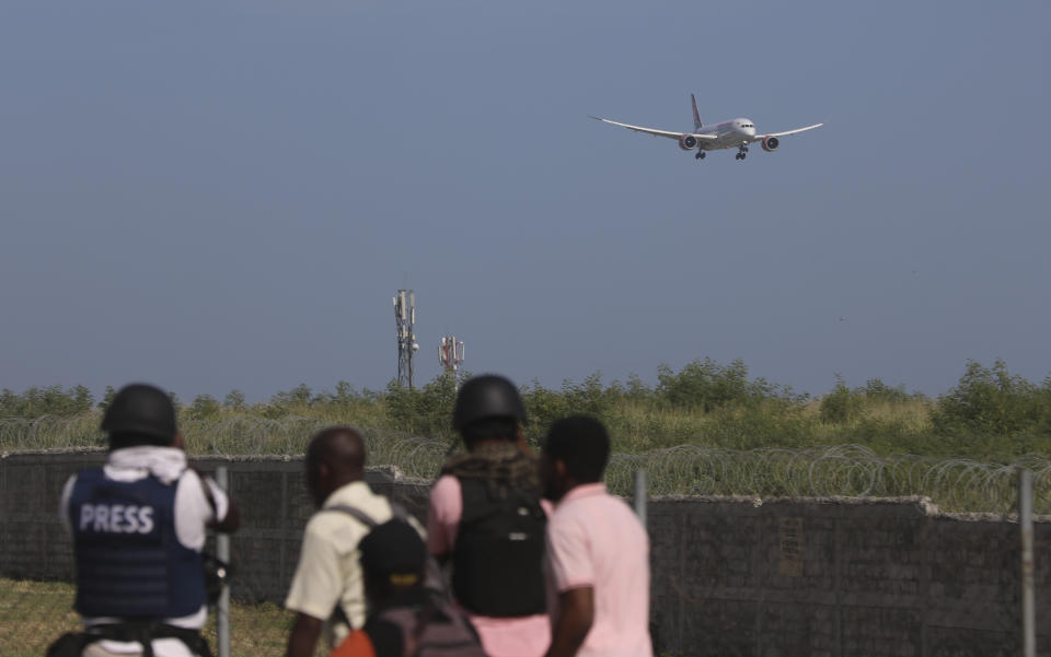 Journalists cover the arrival of a plane carrying police from Kenya at the Toussaint Louverture International Airport in Port-au-Prince, Haiti, Tuesday, June 25, 2024. The first U.N.-backed contingent of foreign police arrived nearly two years after the Caribbean country requested help to quell a surge in gang violence. (AP Photo/Odelyn Joseph)