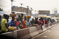 People watch as Secretary of State Antony Blinken's motorcade moves through Kinshasa, Congo, Tuesday, Aug. 9, 2022. Blinken is on a ten day trip to Cambodia, Philippines, South Africa, Congo, and Rwanda. (AP Photo/Andrew Harnik, Pool)