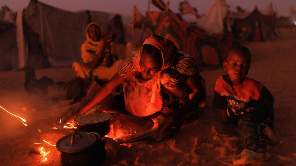 Newly arrived refugees from Sudan cook food over fires outside their makeshift shelters, on April 24, 2024 near Adré, Chad. - Dan Kitwood/Getty Images