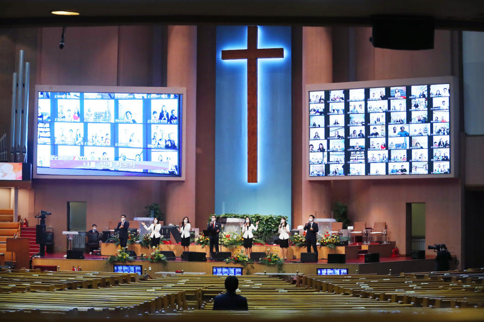 Members of the choir wearing face masks to help protect against the spread of the coronavirus sing a hymn during a service at the Yoido Full Gospel Church in Seoul, South Korea, Sunday, Sept. 20, 2020. South Korea's new coronavirus tally has fallen below 100 for the first time in more than a month. (AP Photo/Ahn Young-joon)