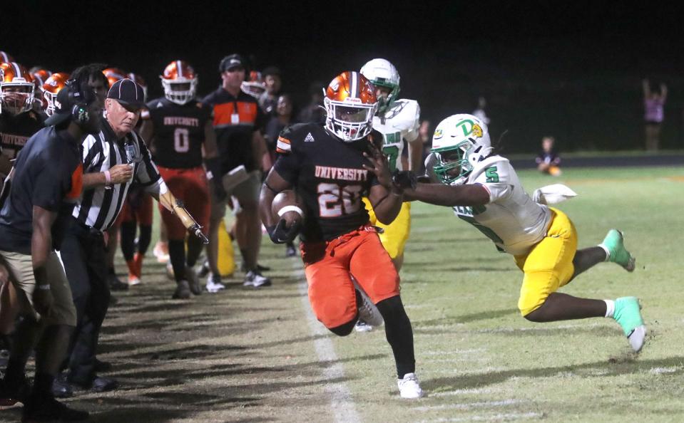 University's Beechie Morris (20) is pushed out of bounds by a DeLand defender, Friday, Oct. 20, 2023.