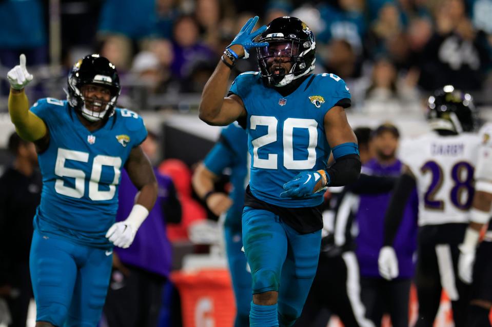 Jacksonville Jaguars safety Daniel Thomas (20) celebrates his open field tackle on a kickoff return with linebacker Shaquille Quarterman (50) during the third quarter of a regular season NFL football matchup Sunday, Dec. 17, 2023 at EverBank Stadium in Jacksonville, Fla. The Baltimore Ravens defeated the Jacksonville Jaguars 23-7. [Corey Perrine/Florida Times-Union]