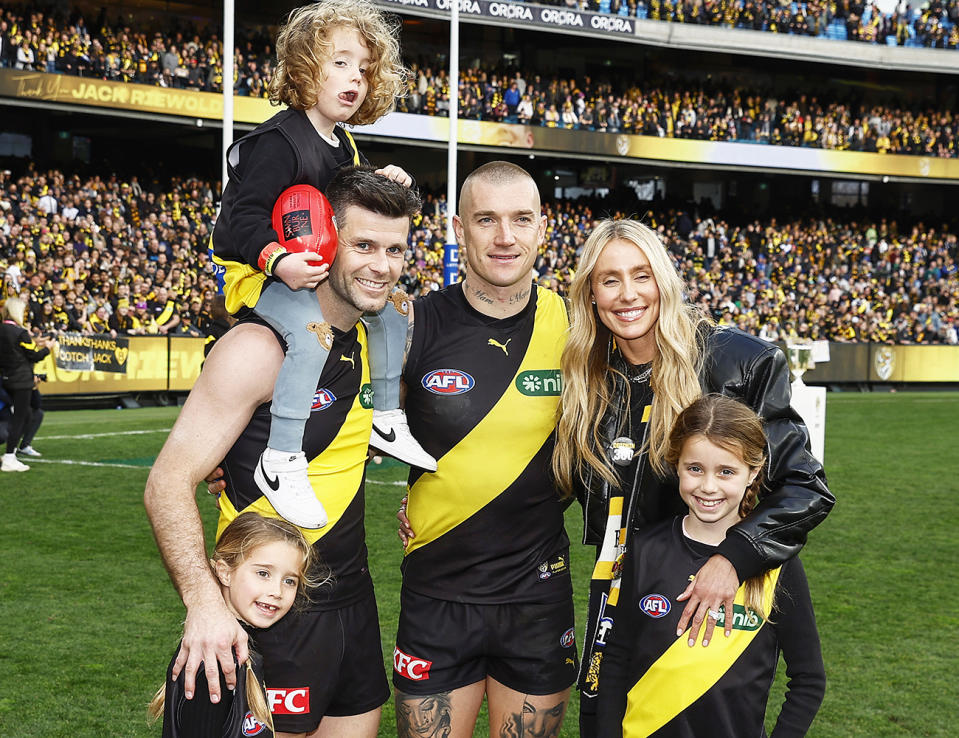 Dustin Martin, pictured here with Trent Cotchin and his family in 2023.