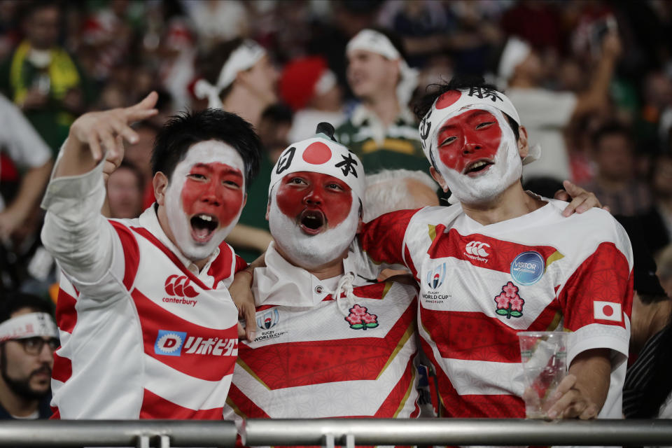 Fans cheer during the Rugby World Cup quarterfinal match at Tokyo Stadium between Japan and South Africa in Tokyo, Japan, Sunday, Oct. 20, 2019. (AP Photo/Jae C. Hong)