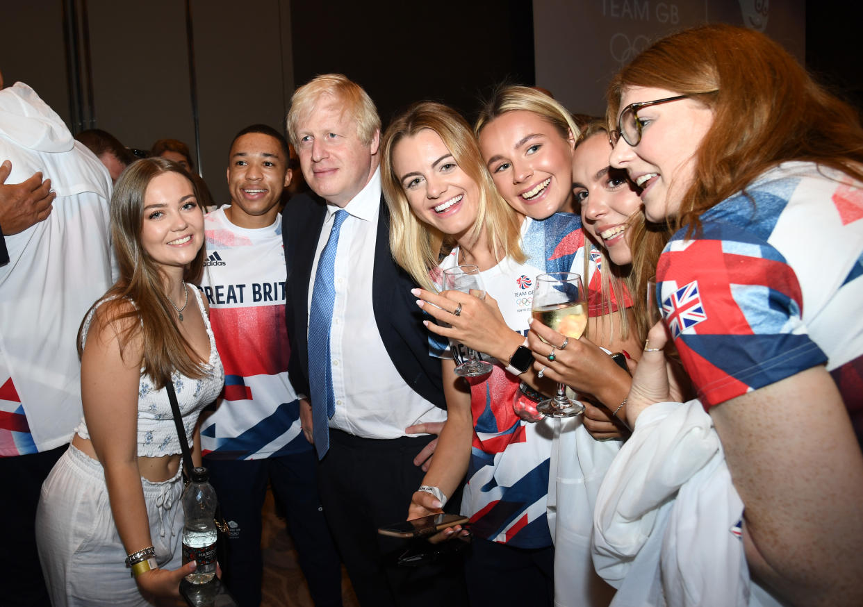 LONDON, ENGLAND - AUGUST 15: Prime Minister, Boris Johnson poses with Joe Fraser and other olympians during The National Lottery's Team GB homecoming event at Hilton London Wembley on August 15, 2021 in London, England. (Photo by Gareth Cattermole/Getty Images for The National Lottery)