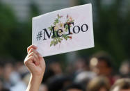 A protester raises a placard reading "#MeToo" during a rally against harassment at Shinjuku shopping and amusement district in Tokyo, Japan, April 28, 2018. Picture taken April 28, 2018. REUTERS/Issei Kato