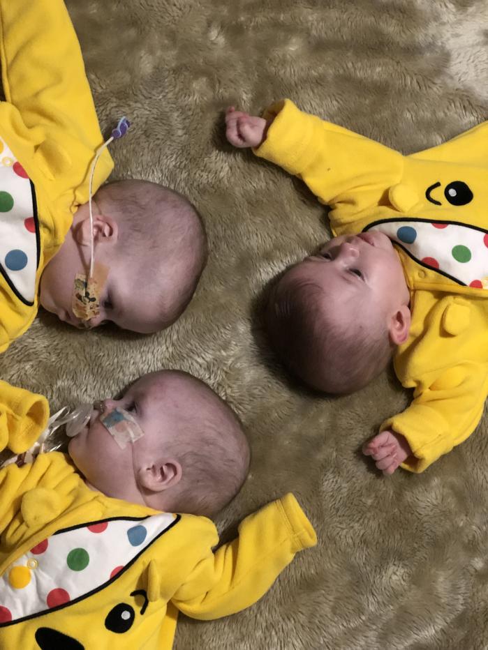 Triplets Rubi-Rose, Payton Jane and Porscha-Mae dressed in Pudsey bear onesies (Guinness World Records)