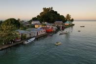 FILE PHOTO: The morning's first rays of sunlight hit the island community of Serua Village, Fiji