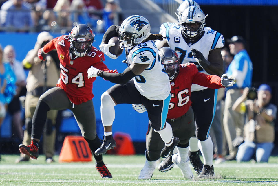 Carolina Panthers running back D'Onta Foreman (33) gains yardage as Tampa Bay Buccaneers defensive tackle Rakeem Nunez-Roches (56) and teammate linebacker Lavonte David (54) pursue during the second half of an NFL football game Sunday, Oct. 23, 2022, in Charlotte, N.C. (AP Photo/Rusty Jones)