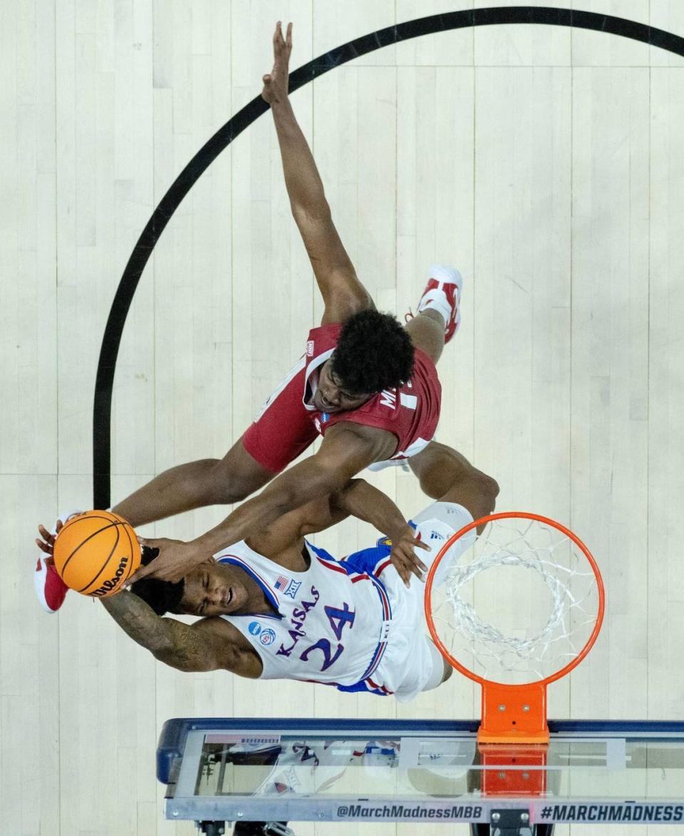 Arkansas forward Makhi Mitchell (15) contests a shot by Kansas forward K.J. Adams Jr. (24) during a second-round college basketball game in the NCAA Tournament Saturday, March 18, 2023, in Des Moines, Iowa.