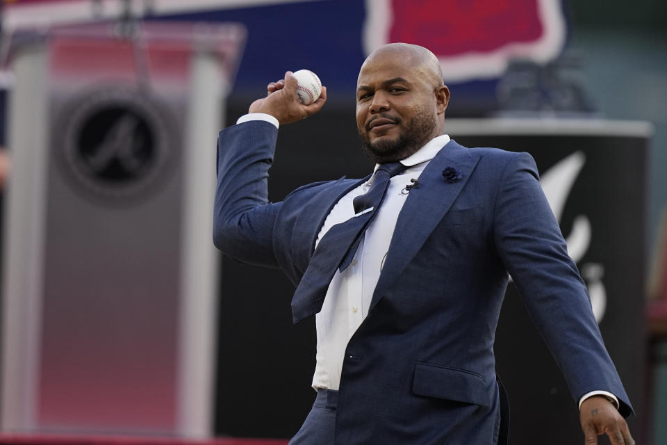 Former Atlanta Braves player, Andruw Jones throws an honorary first pitch, Saturday, Sept. 9, 2023, in Atlanta. Jones who won 10 Gold Gloves in a career that began with 12 seasons in Atlanta, became the 11th Braves player or manager to have his number retired on Saturday night. The honor could add momentum to his candidacy for the Baseball Hall of Fame. Jones' 25 was retired before the Braves' game against the Pittsburgh Pirates. (AP Photo/Brynn Anderson)