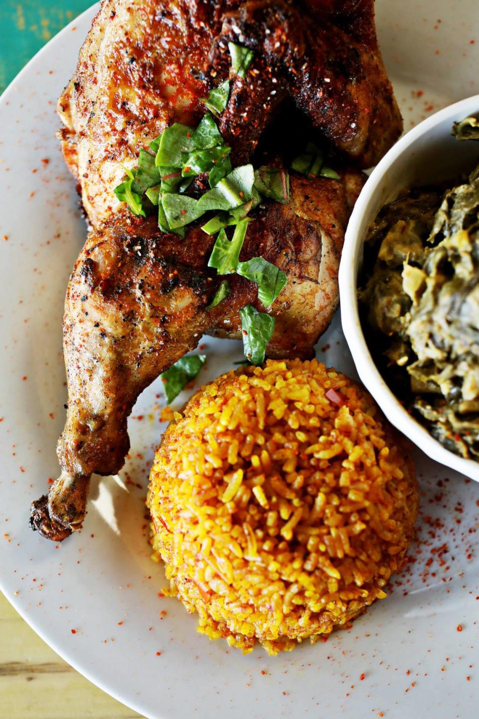 Zweli’s in Durham serves a half chicken with a side of collard greens cooked with peanut butter and Jollof rice.