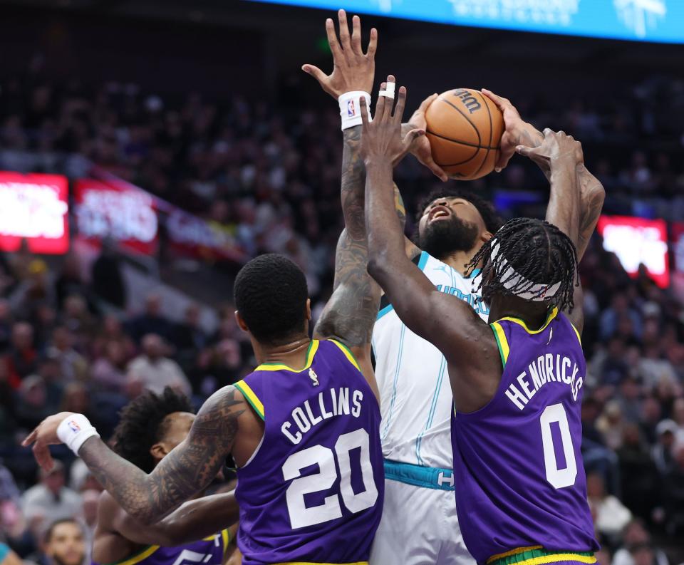 Utah Jazz forward John Collins (20) and Jazz forward Taylor Hendricks (0) defend Charlotte Hornets center Nick Richards (4) in Salt Lake City on Thursday, Feb. 22, 2024. | Jeffrey D. Allred, Deseret News