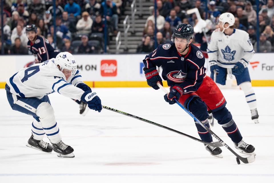 Blue Jackets center Adam Fantilli shoots the puck against Toronto center David Kampf on Dec. 29.