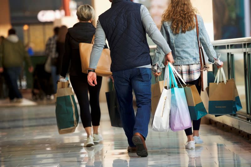 FILE PHOTO: Shoppers carry bags of purchased merchandise at the King of Prussia Mall, United States' largest retail shopping space, in King of Prussia