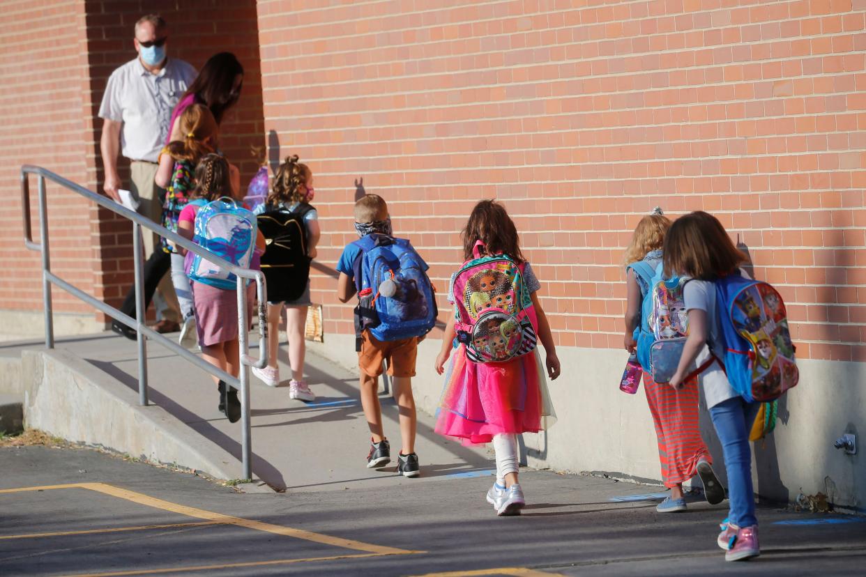 Students walk into Liberty Elementary School during the first day of class on Monday, Aug. 17, 2020, in Murray, Utah.