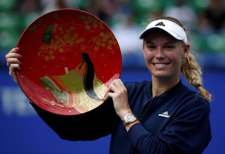 Tennis - Pan Pacific Open Women's Singles Final match - Ariake Coliseum, Tokyo, Japan - 25/09/16. Caroline Wozniacki of Denmark holds the winning plate during an awarding ceremony after winning the final match against Naomi Osaka of Japan. REUTERS/Issei Kato