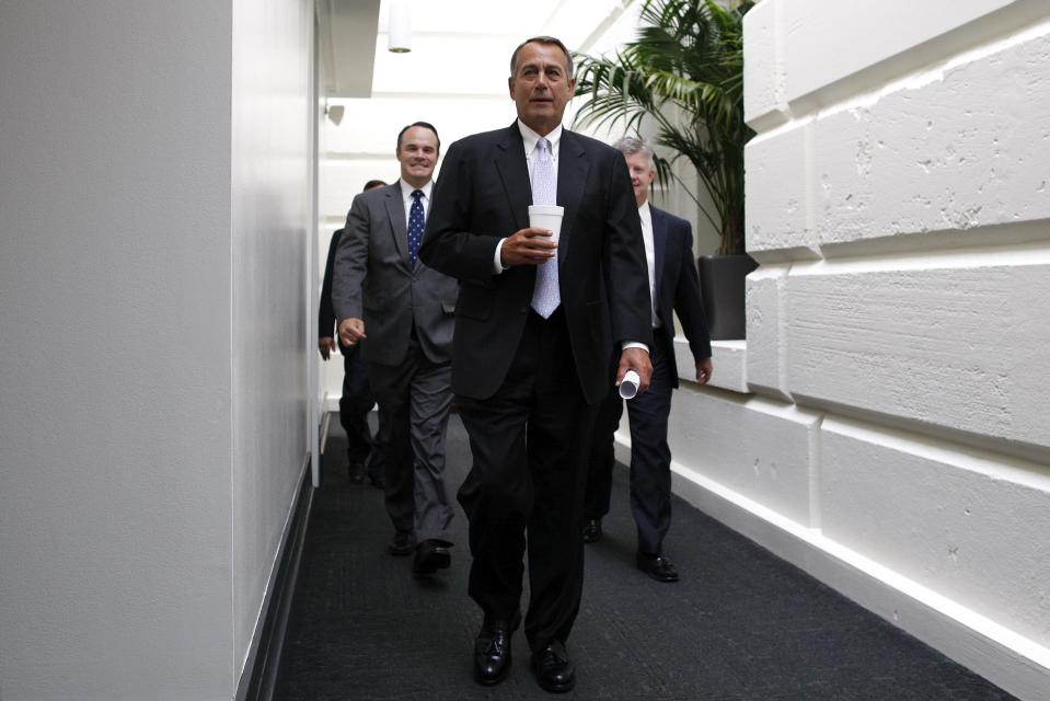 Boehner arrives for a closed-door meeting of the House Republican caucus during a rare Saturday session at the U.S. Capitol in Washington