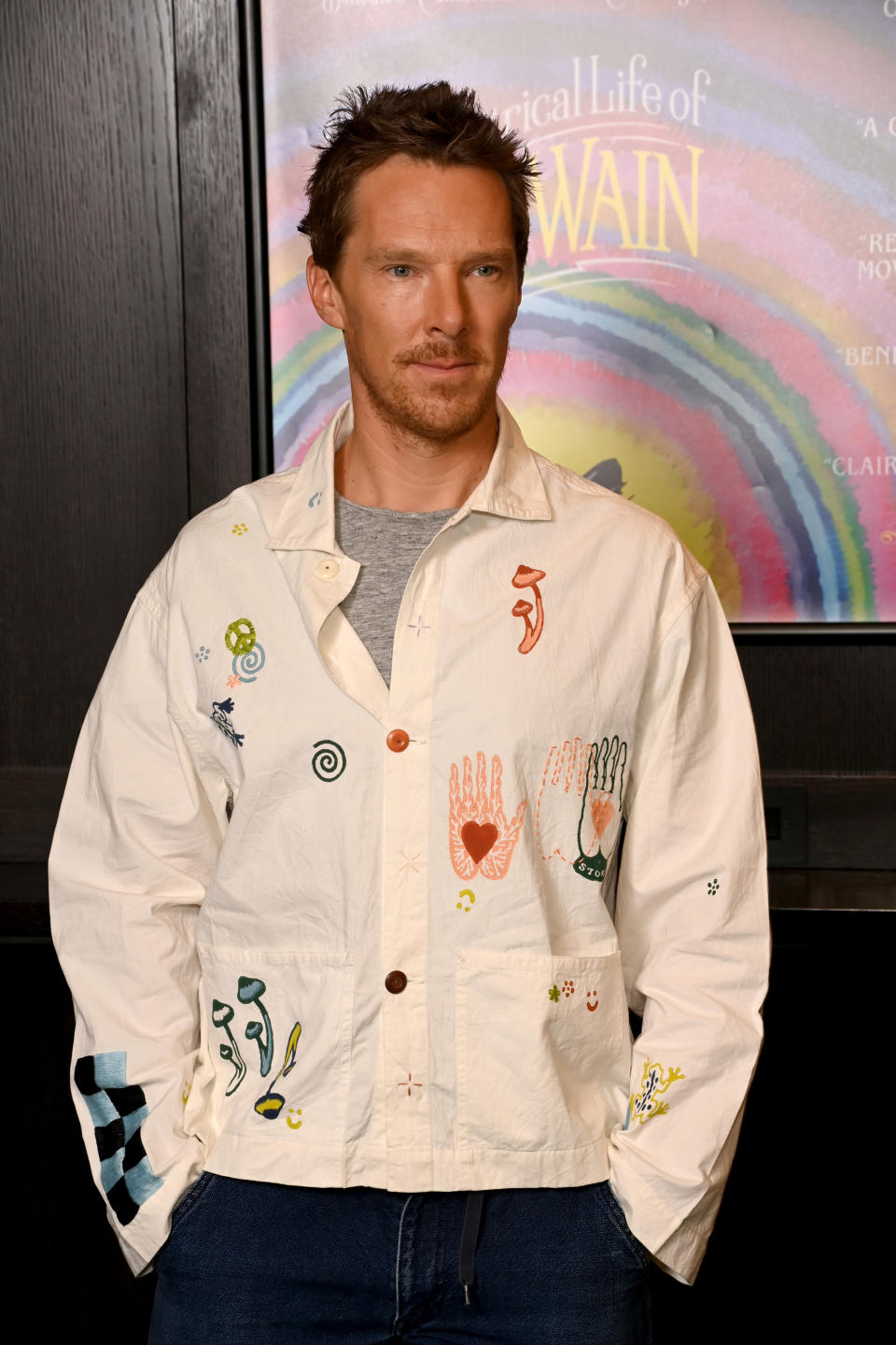 Cumberbatch wears a loose button-down shirt and jeans at an event