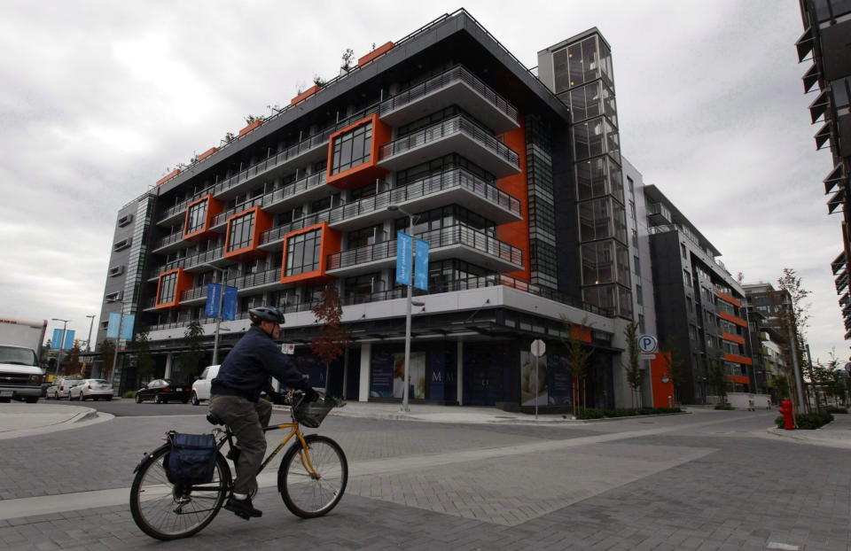 A cyclist rides through the Millennium Water development which was the athletes’ village during the 2010 Winter Olympics in Vancouver, B.C., on October 7, 2010. (THE CANADIAN PRESS/Darryl Dyck)