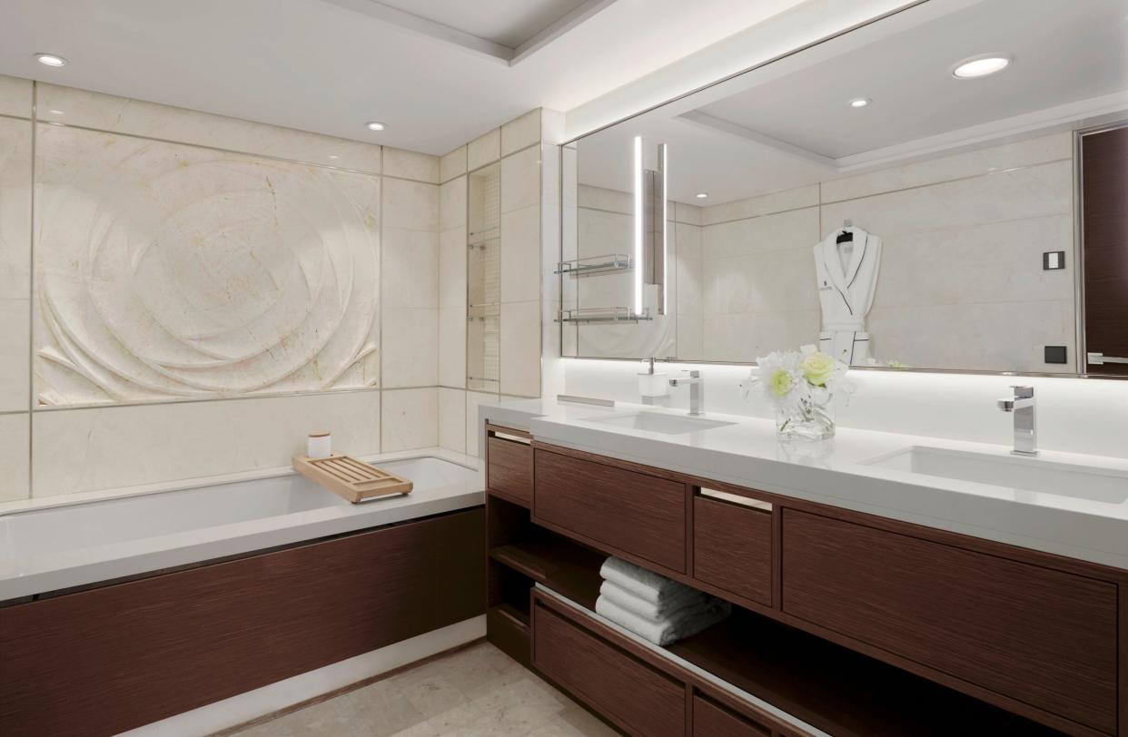 The suites have double vanity bathrooms, private terraces, and floor-to-ceiling windows.