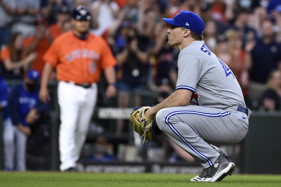 Toronto Blue Jays starting pitcher Ross Stripling reacts after walking Houston Astros' Alex Bregman with the bases loaded during the second inning of baseball game, Friday, May 7, 2021, in Houston. (AP Photo/Eric Christian Smith)