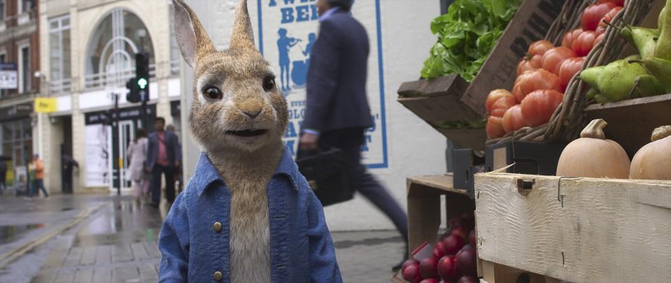 A computer-generated rabbit beside a vegetable stand