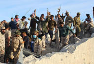 Fighters of Libyan forces allied with the U.N.-backed government celebrate as they are close to securing last Islamic State holdouts in Sirte, Libya December 5, 2016. REUTERS/Ayman Sahely