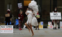 A dancer performs in protest opposite the Central Criminal Court, the Old Bailey, in London, Monday, Sept. 21, 2020, as the Julian Assange extradition hearing to the US continues. (AP Photo/Frank Augstein)