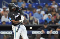 Miami Marlins' Josh Bell hits during the first inning of a baseball game against the Pittsburgh Pirates, Friday, March 29, 2024, in Miami. Bell was safe at first on a fielding error by Pittsburgh Pirates third baseman Ke'Bryan Hayes. (AP Photo/Wilfredo Lee)