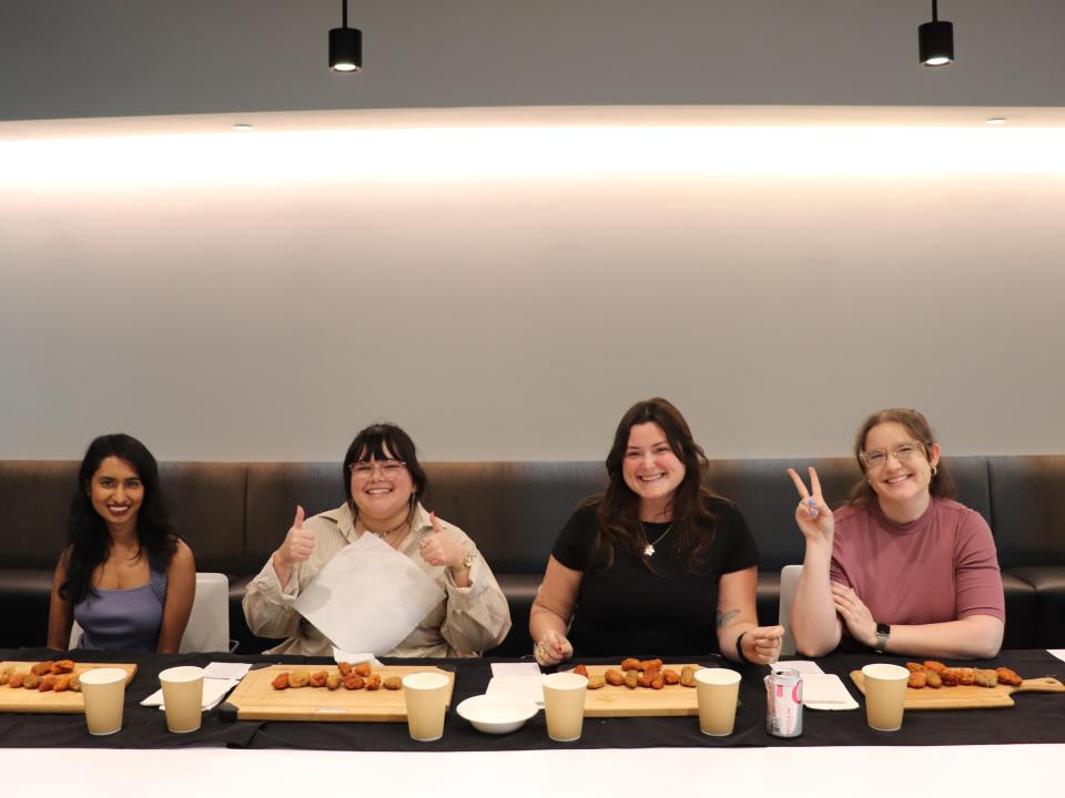 Four of Insider's reporters preparing to eat hot wings.