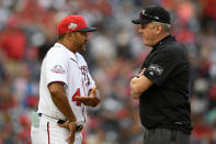 FILE - In this April 28, 2018, file photo, Washington Nationals manager Dave Martinez, left, talks with second base umpire Mike Everitt during a pitching change in the 10th inning of the team's baseball game against the Arizona Diamondbacks in Washington. Major League Baseball will start each extra inning this season by putting a runner on second base. This rule has been used since 2018 in the minor leagues, where it created more action and settled games sooner. “I haven’t met anyone so far that likes it,” Martinez said. (AP Photo/Nick Wass, File)