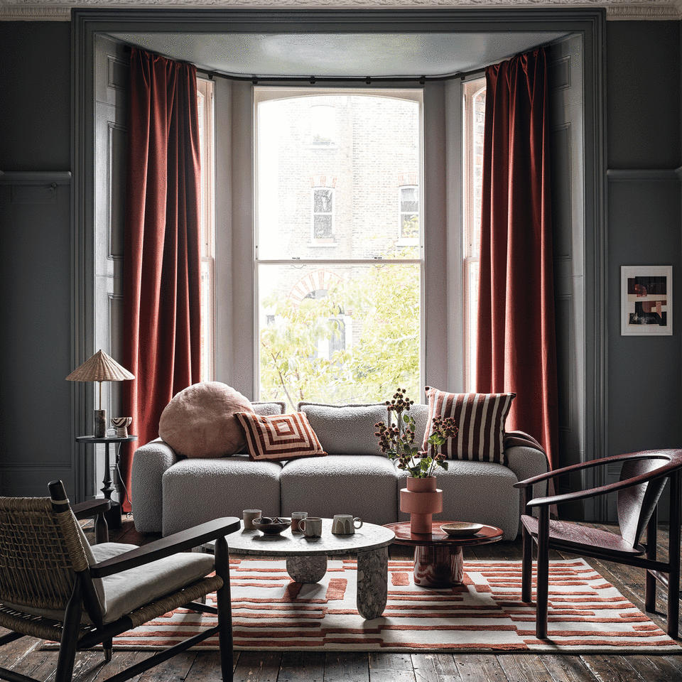 Navy living room with red curtains