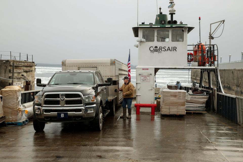 Ron Atkins secures the trailer just after he backed it on the ferry at the Arnold Freight Co. freight terminal in St. Ignace on Monday, April 4, 2022. He loaded his truck and trailer on the ferry to take the first six horses that make up three teams that will be moved to Mackinac Island.