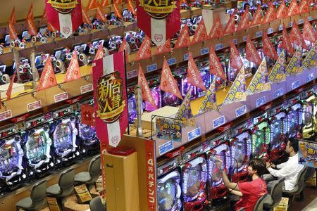 Visitors play Pachinko at a Dynam pachinko parlour in Honjo, north of Tokyo August 4, 2014. REUTERS/Issei Kato